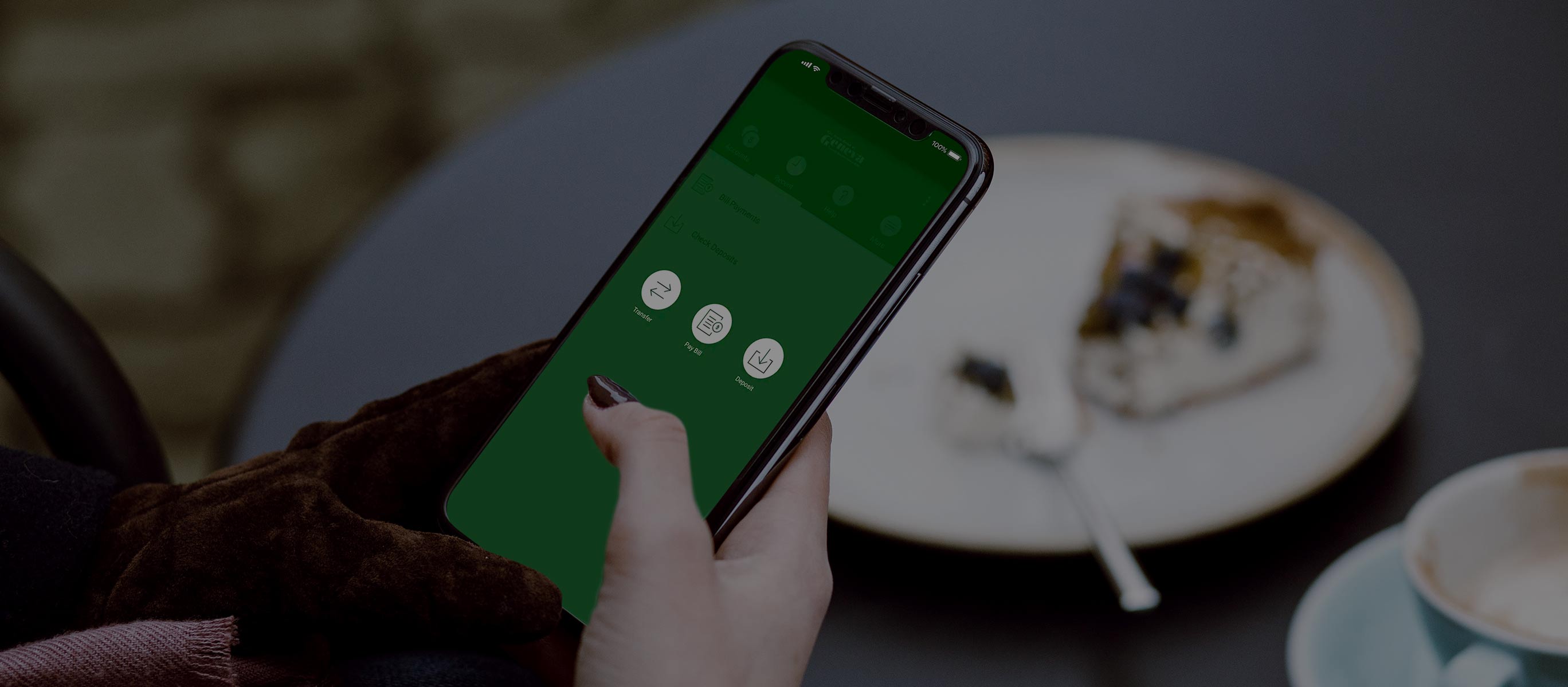 Hand holding smartphone with green app screen